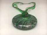 Murano green glass pendant, circle with 925 silver foil on a ribbon necklace.